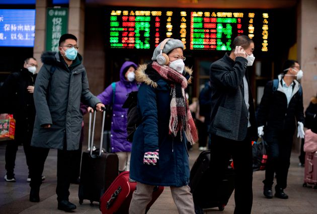 Passengers wearing facemasks arrive from different provinces at the Beijing Railway Station on February 1, 2020. - China faced deepening isolation over its coronavirus epidemic as the death toll soared to 259, with the United States and Australia leading a growing list of nations to impose extraordinary Chinese travel bans. (Photo by NOEL CELIS / AFP) (Photo by NOEL CELIS/AFP via Getty Images)