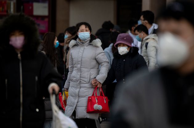 Travellers wearing facemasks arrive from various provinces at the Beijing Railway Station on February 3, 2020.(Photo by NOEL CELIS/AFP via Getty Images)