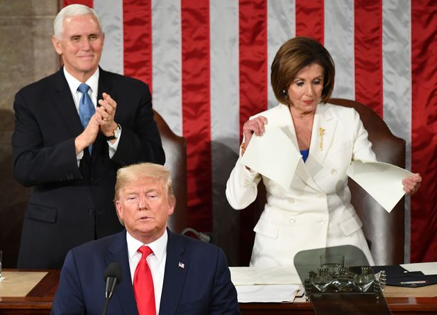 US Vice President Mike Pence claps as Speaker of the US House of Representatives Nancy Pelosi appears to rip a copy of US President Donald Trumps speech after he delivers the State of the Union address at the US Capitol in Washington, DC, on February 4, 2020. (Photo by MANDEL NGAN / AFP) (Photo by MANDEL NGAN/AFP via Getty Images)