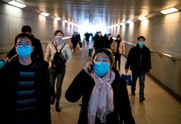 Passengers wearing protective face masks arrive at the Shanghai South railway station in Shanghai on February 9, 2020. - The death toll from the novel coronavirus surged past 800 in mainland China on February 9, overtaking global fatalities in the 2002-03 SARS epidemic, even as the World Health Organization said the outbreak appeared to be 'stabilising'. (Photo by NOEL CELIS / AFP) (Photo by NOEL CELIS/AFP via Getty Images)