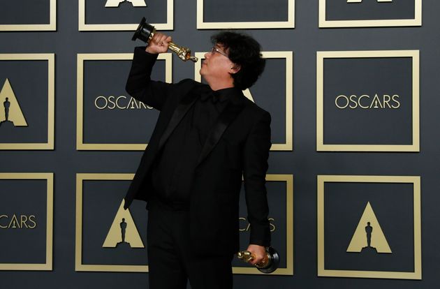 Bong Joon Ho poses with two Oscars, one for Best Director and one for Best International Feature Film for 'Parasite' in the photo room during the 92nd Academy Awards in Hollywood, Los Angeles, California, U.S., February 9, 2020. REUTERS/Lucas Jackson