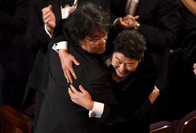 Bong Joon Ho, left, and Kang-Ho Song celebrate before going on stage to accept the award for best picture for 'Parasite'at the Oscars on Sunday, Feb. 9, 2020, at the Dolby Theatre in Los Angeles. (AP Photo/Chris Pizzello)