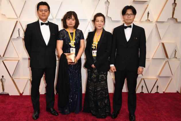 South Korean producer Gary Byung-seok Kam, South Korean director Yi Seung-jun, Mina Kim and Hyunju Oh for the short documentary 'In the abscence' arrive for the 92nd Oscars at the Dolby Theatre in Hollywood, California on February 9, 2020. (Photo by Robyn Beck / AFP) (Photo by ROBYN BECK/AFP via Getty Images)