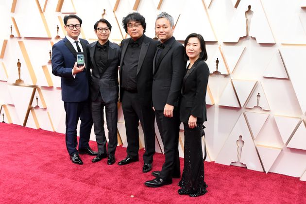 HOLLYWOOD, CALIFORNIA - FEBRUARY 09: Director Bong Joon-ho (C) with cast and crew of 'Parasite' attends the 92nd Annual Academy Awards at Hollywood and Highland on February 09, 2020 in Hollywood, California. (Photo by Steve Granitz/WireImage)