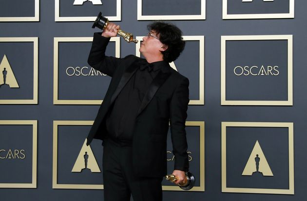 Bong Joon Ho poses with two Oscars, one for Best Director and one for Best International Feature Film for 'Parasite' in the photo room during the 92nd Academy Awards in Hollywood, Los Angeles, California, U.S., February 9, 2020. REUTERS/Lucas Jackson