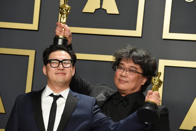 Han Jin Won, left, and Bong Joon Ho, winners of the award for best original screenplay for 'Parasite', pose in the press room at the Oscars on Sunday, Feb. 9, 2020, at the Dolby Theatre in Los Angeles. (Photo by Jordan Strauss/Invision/AP)