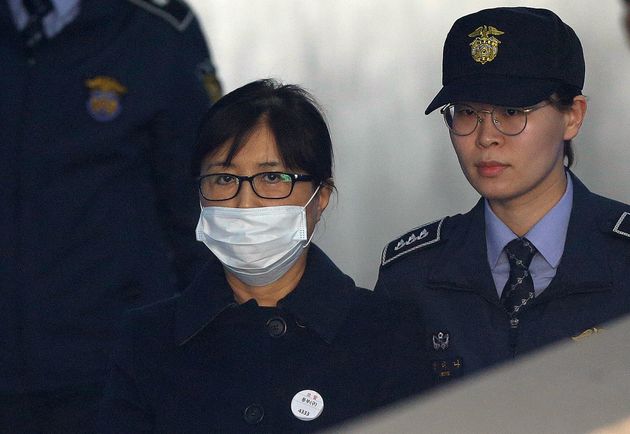 Choi Soon-sil, center, a confidante of former South Korean President Park Geun-hye, arrives at the Seoul Central District Court in Seoul, South Korea, Tuesday, Feb. 13, 2018. (AP Photo/Ahn Young-joon)