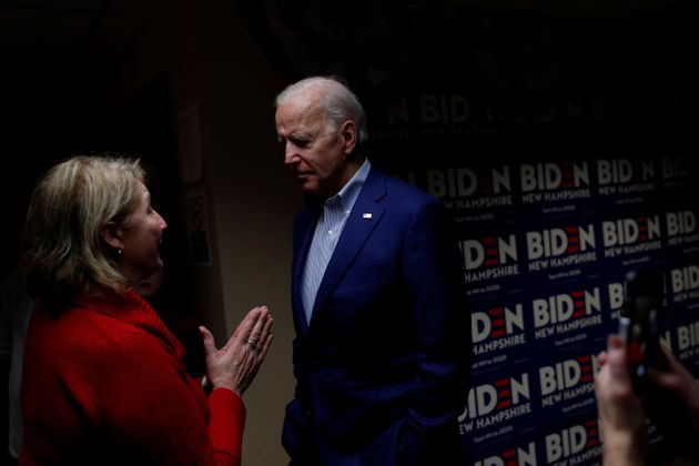 Democratic 2020 U.S. presidential candidate and former Vice President Joe Biden speaks with a volunteer at a campaign office in Salem, New Hampshire, U.S., February 10, 2020. REUTERS/Carlos Barria