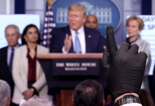 도널드 트럼프 미국 대통령 등이 참석한 코로나19 브리핑에서 한 언론인이 고무장갑을 착용한 채 손을 들어 질문을 신청하고 있다. 2020년 3월16일.