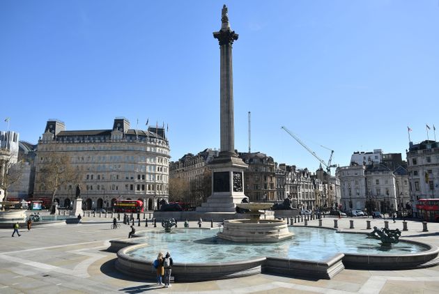 A near empty Trafalgar Square is pictured in the sunshine at lunch time, central London, March 23, 2020, as governments scramble to defend their own economies against the coronavirus COVID-19 pandemic in order to ward off a long-term global recession and future waves of infections. (Photo by Ben STANSALL / AFP) (Photo by BEN STANSALL/AFP via Getty Images)