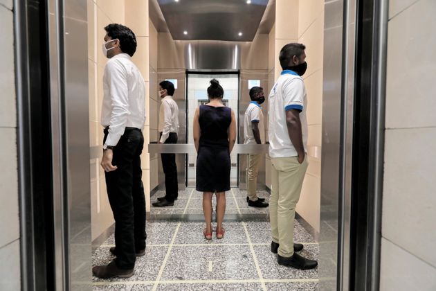 정부 지침에 따라 2개월 동안의 봉쇄조치를 끝내고 다시 문을 연 사무실들이 있는 세계무역센터 엘리베이터 안에서 사회적 거리두기를 실천하는 사람들. 콜롬보, 스리랑카. 2020년 5월11일.