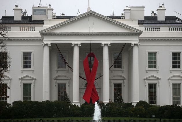 2015년 12월 1일 미국 워싱턴 DC 백악관의 모습. 세계 에이즈의 날을 기념하는 빨간색 리본을 걸었다. 세계 에이즈의 날은 1988년부터 12월 1일에 기념되어 왔으며, HIV 감염의 확산으로 인한 에이즈의 대유행에 대한 인식을 높이고 사망자를 애도하기 위해 노력하고 있다.