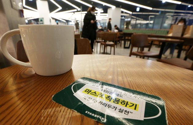 테이크아웃만 가능했던 카페 매장 내 취식이 가능해진 18일 오후 경기도 수원시내 한 커피 전문점에서 좌석이 50%만 활용돼 좌석 간 간격이 떨어져 있다.  