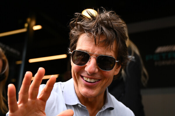 NORTHAMPTON, ENGLAND - JULY 03: Tom Cruise walks in the Paddock prior to the F1 Grand Prix of Great Britain at Silverstone on July 03, 2022 in Northampton, England. (Photo by Clive Mason/Getty Images)