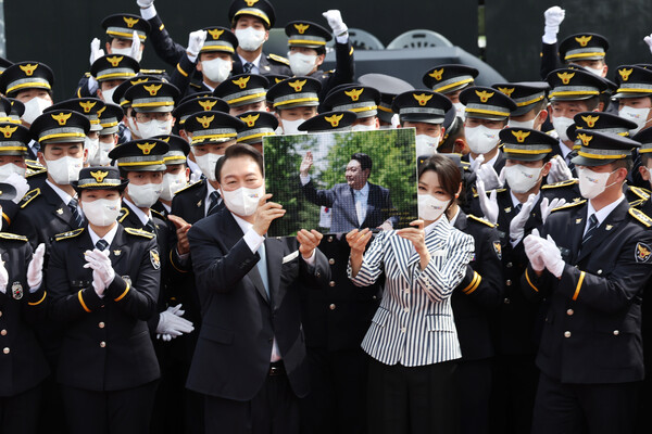 윤석열 대통령과 김건희 여사가 19일 충북 충주 중앙경찰학교 대운동장에서 열린 중앙경찰학교 310기 졸업식에서 졸업생들로부터 받은 선물을 들고 기념촬영을 하고 있다. (2022.8.19) 출처 : 대통령실 제공