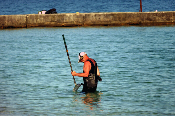 ODESA, UKRAINE - MAY 25, 2021 - A man explores the seabed with a metal detector by the Black Sea in Odesa, southern Ukraine. (Photo credit should read Yulii Zozulia/ Ukrinform/Future Publishing via Getty Images)