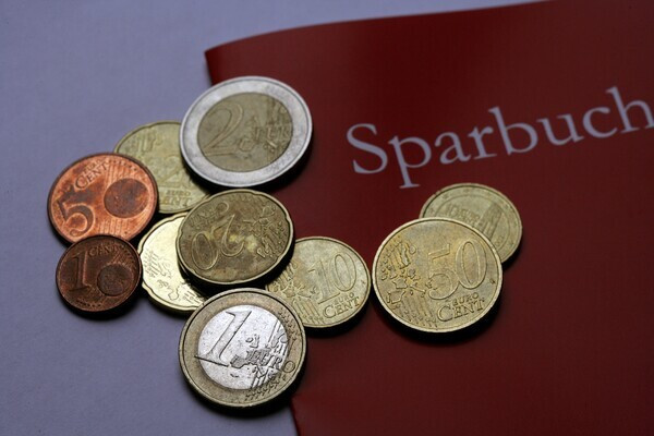 GERMANY - DECEMBER 16: Bankbook with Euro coins. (Photo by Ulrich Baumgarten via Getty Images)