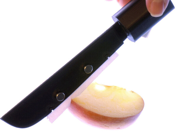 연구진이 직접 제작한 종이칼로 사과를 자르는 모습. 프린터용 도트 매트릭스 용지를 칼날로 사용했다. ⓒ덴마크 공대 제공